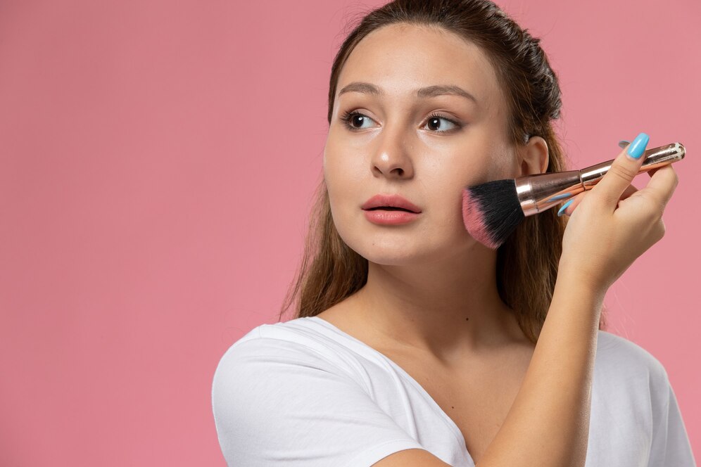 front view of young girl doing make up